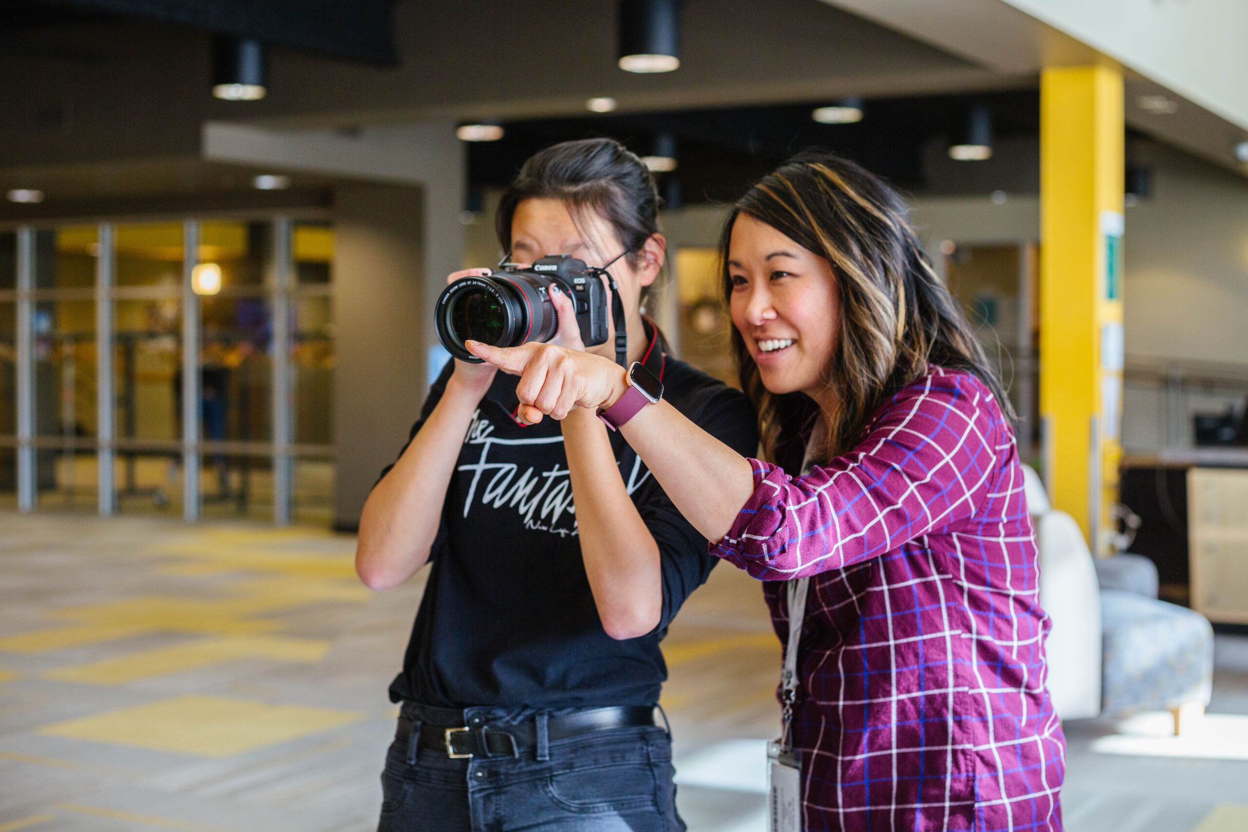 New Life Academy student receiving hands‑on photography guidance during an internship program.