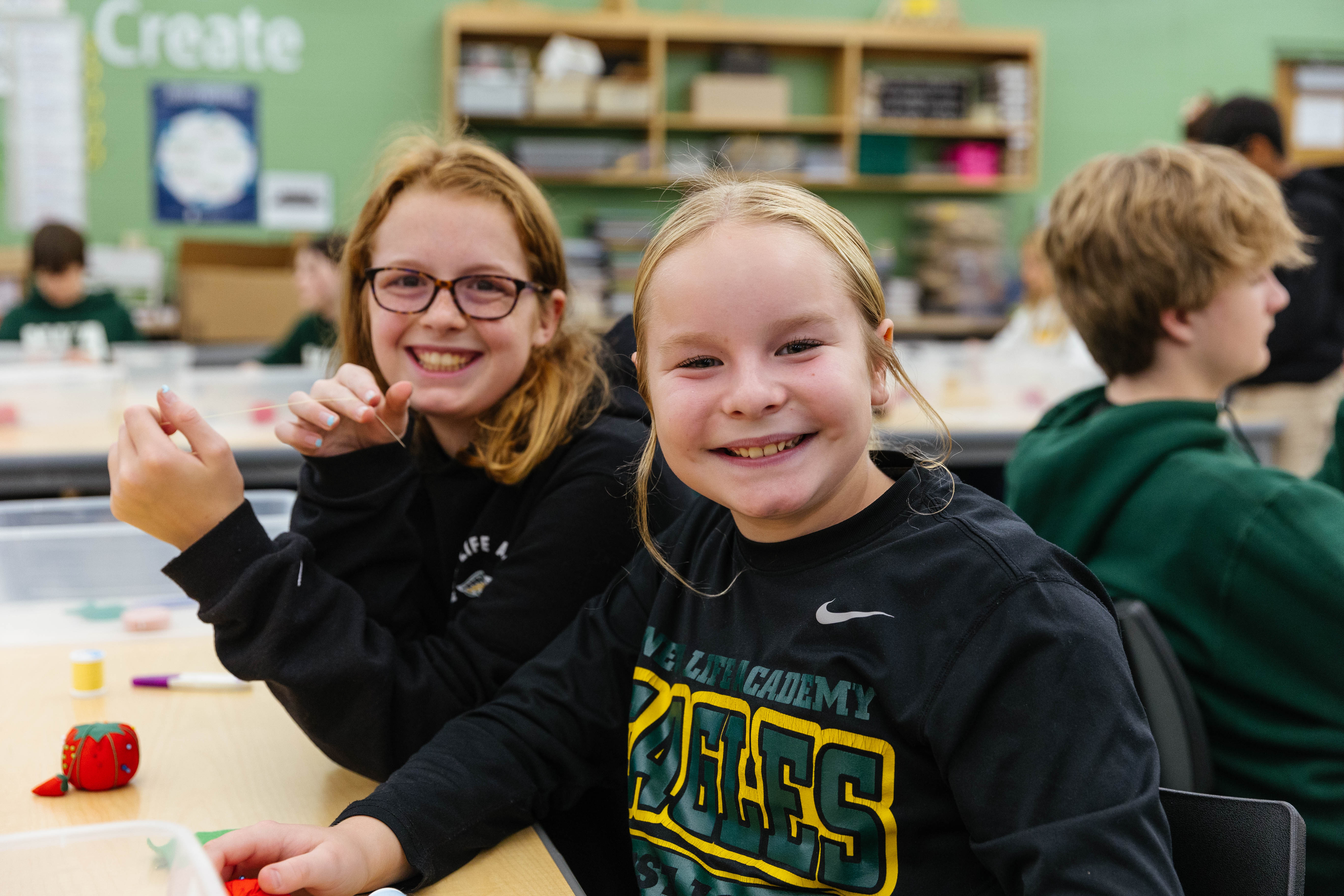 Middle School student in the Innovation Center working on building a game out of cardboard.