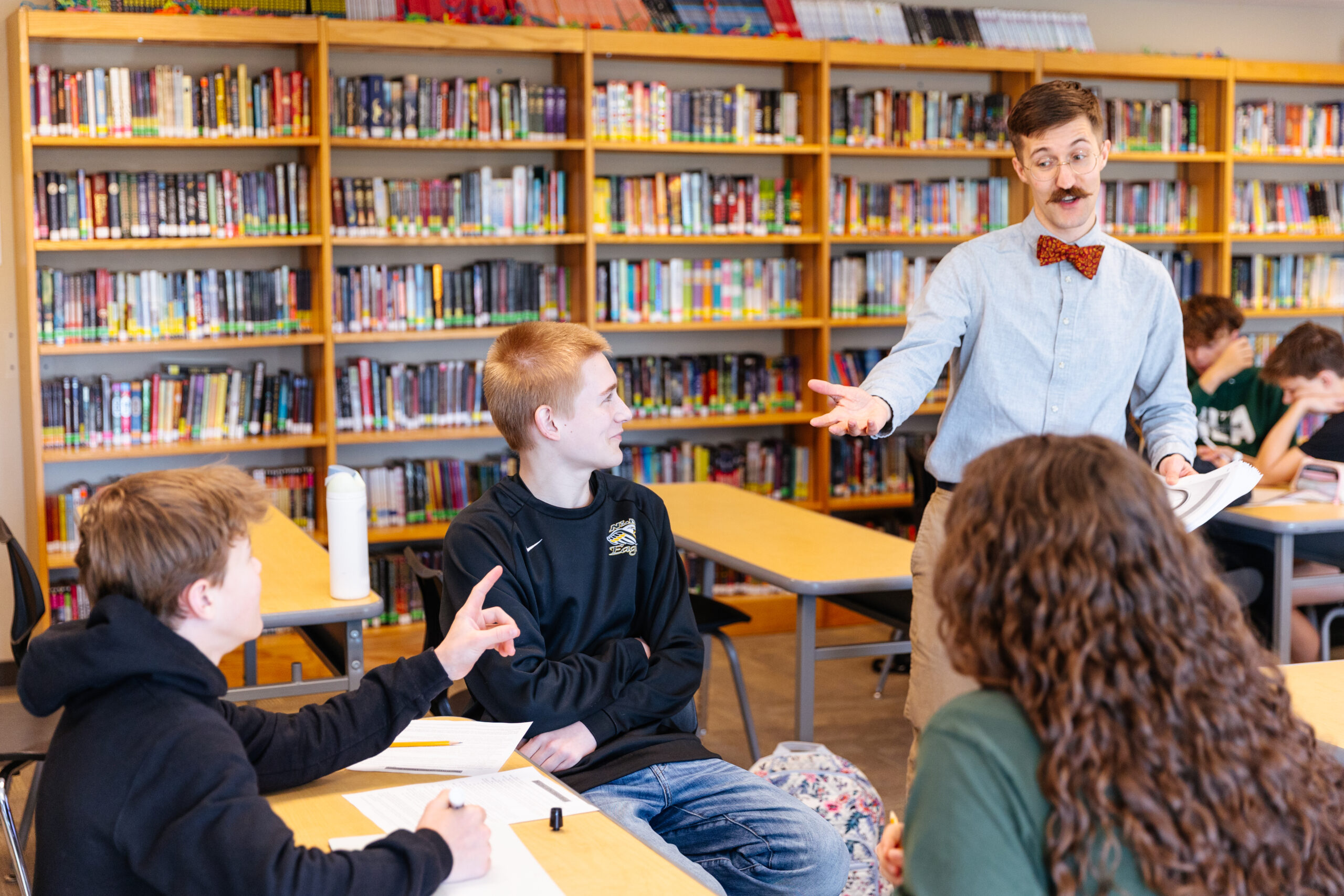 New Life Middle School English Teacher Dan Nelson interacts with students in class