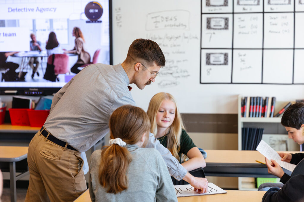 Middle School English Teacher Dan Nelson teaching hands on learning in class