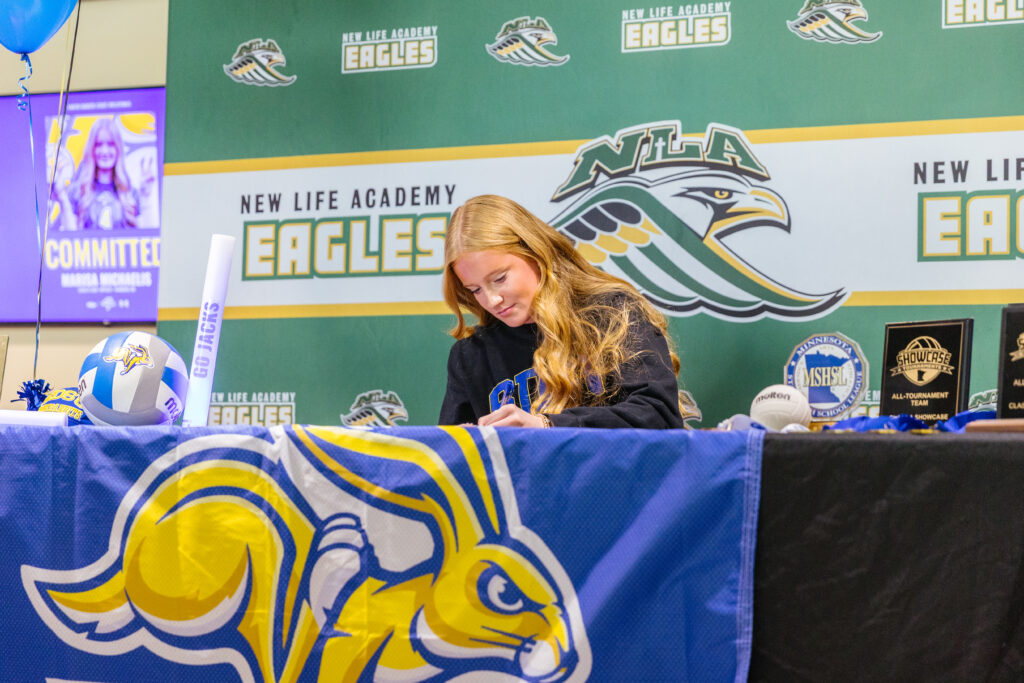 New Life Academy Varsity Volleyball player Marisa M participates in signing day as she commits to playing D1 Volleyball at SDSU