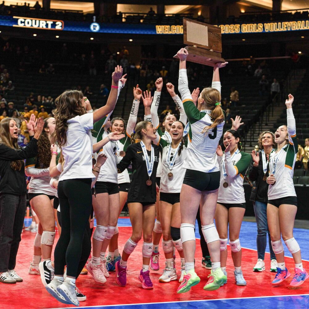 Four New Life Academy students smiling outdoors while holding Annual Fund signs and boxes during the 2025 campaign kickoff.