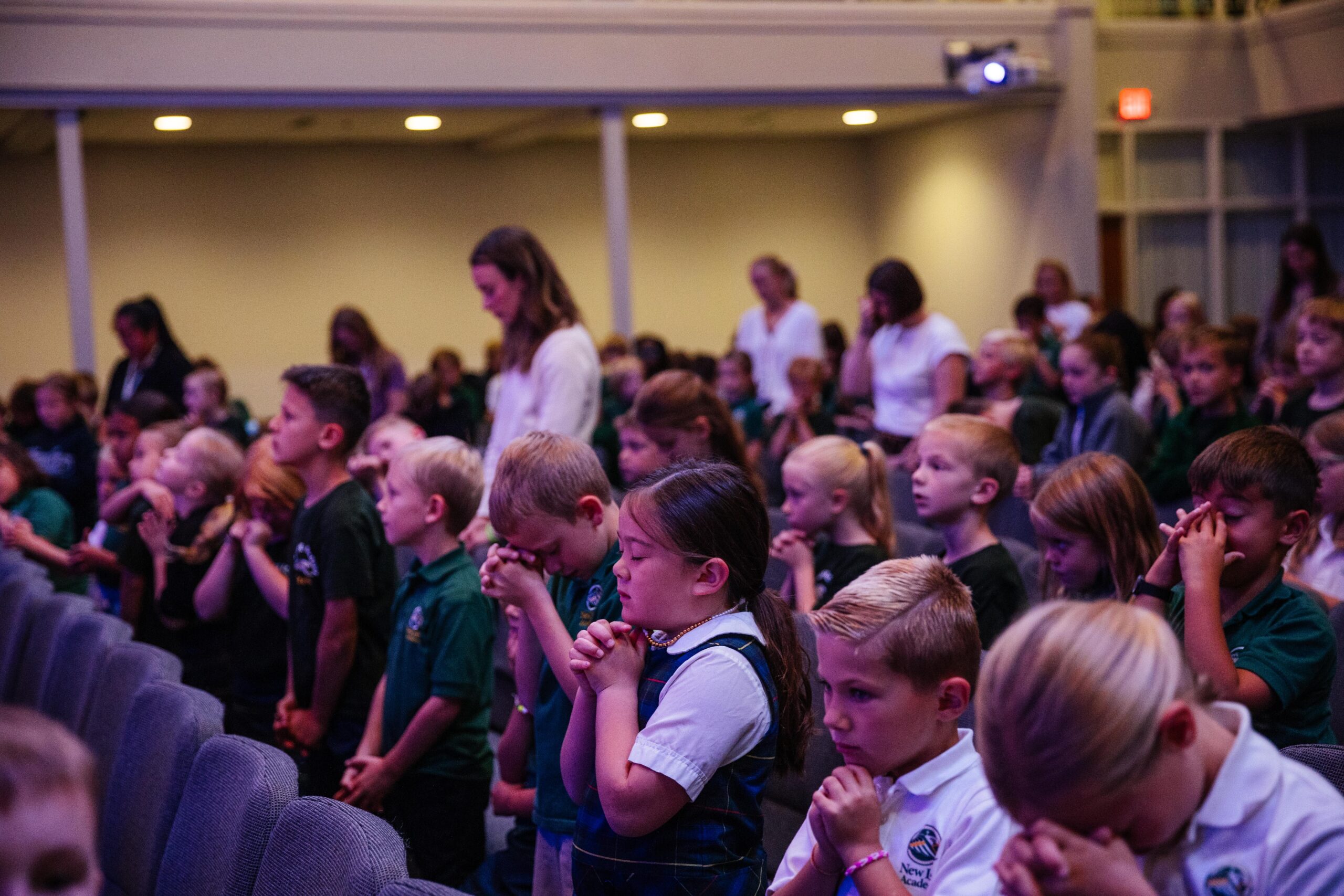 Lower school student participating in chapel worship at New Life Academy