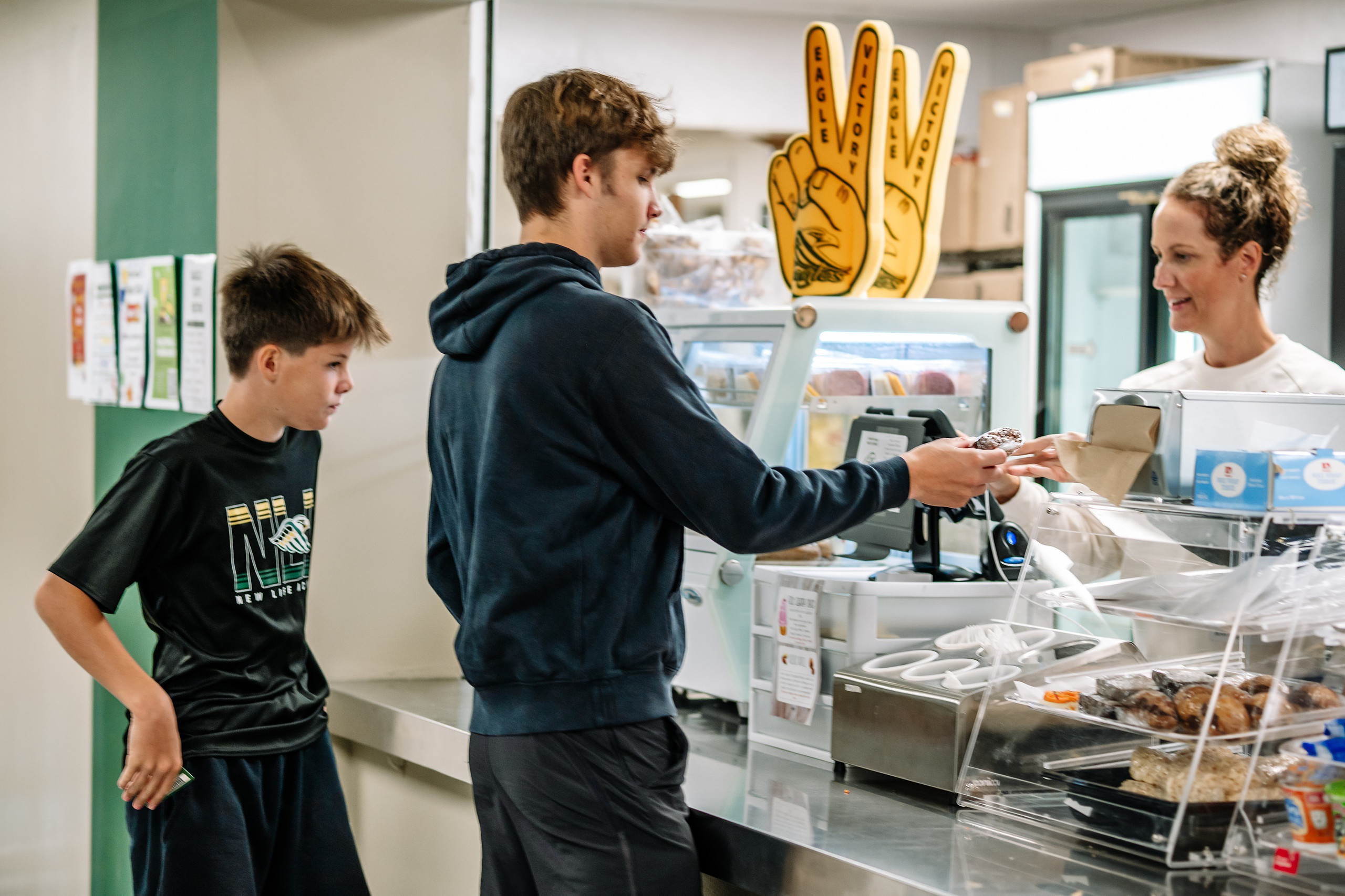 Hospitality team member serving students in the New Life Academy school café
