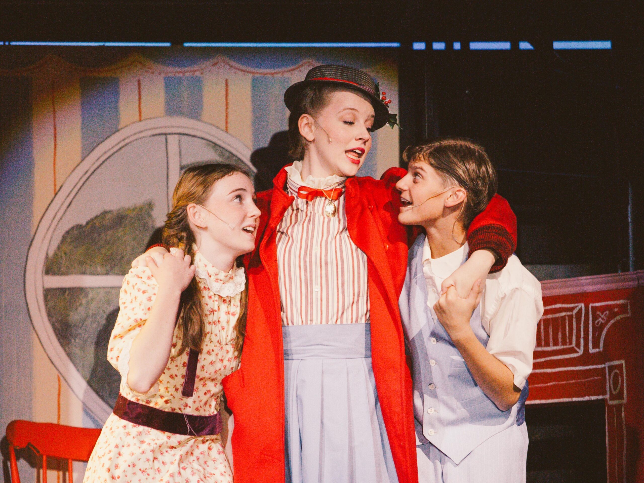 Cast performing on stage during New Life Academy’s theater production of Mary Poppins.