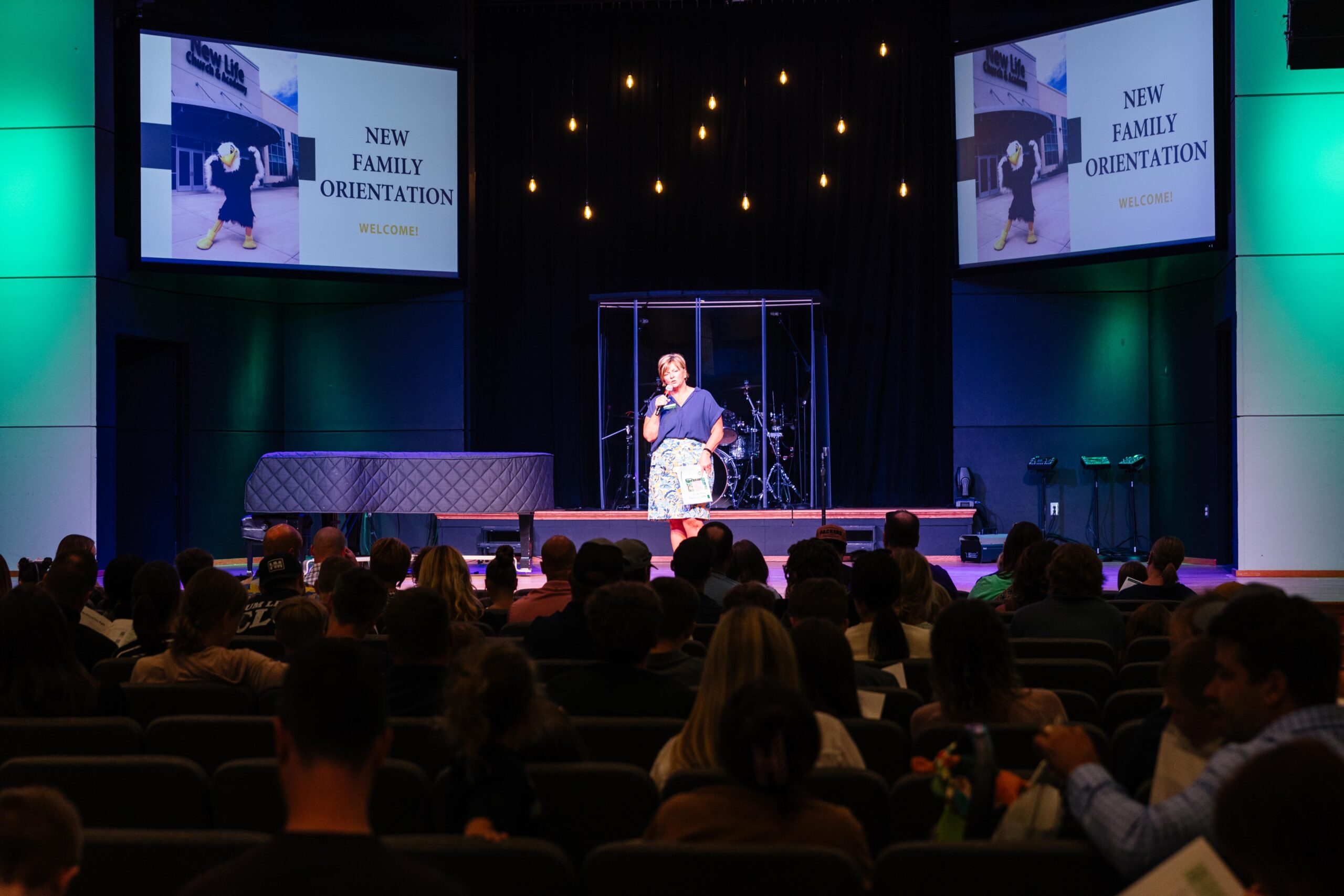 Families and students gathering in the lobby area at New Life Academy during the New Family Orientation event with staff welcoming attendees.