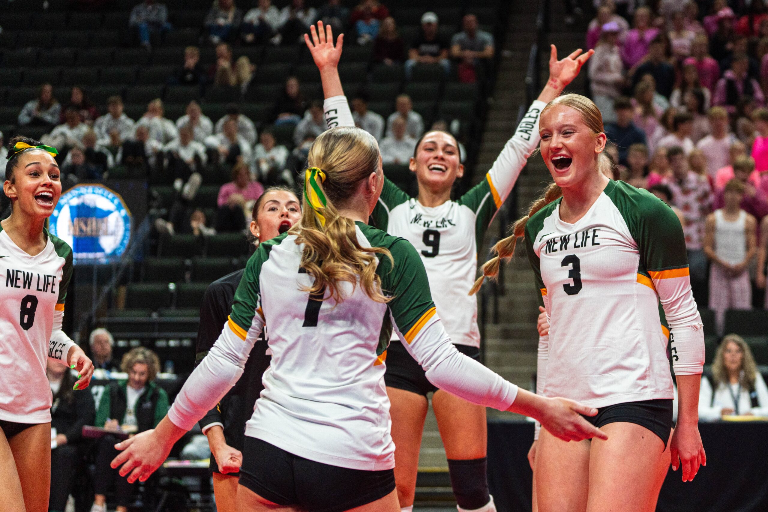 New Life Academy girls varsity volleyball team celebrating a point during the 2025 state tournament match