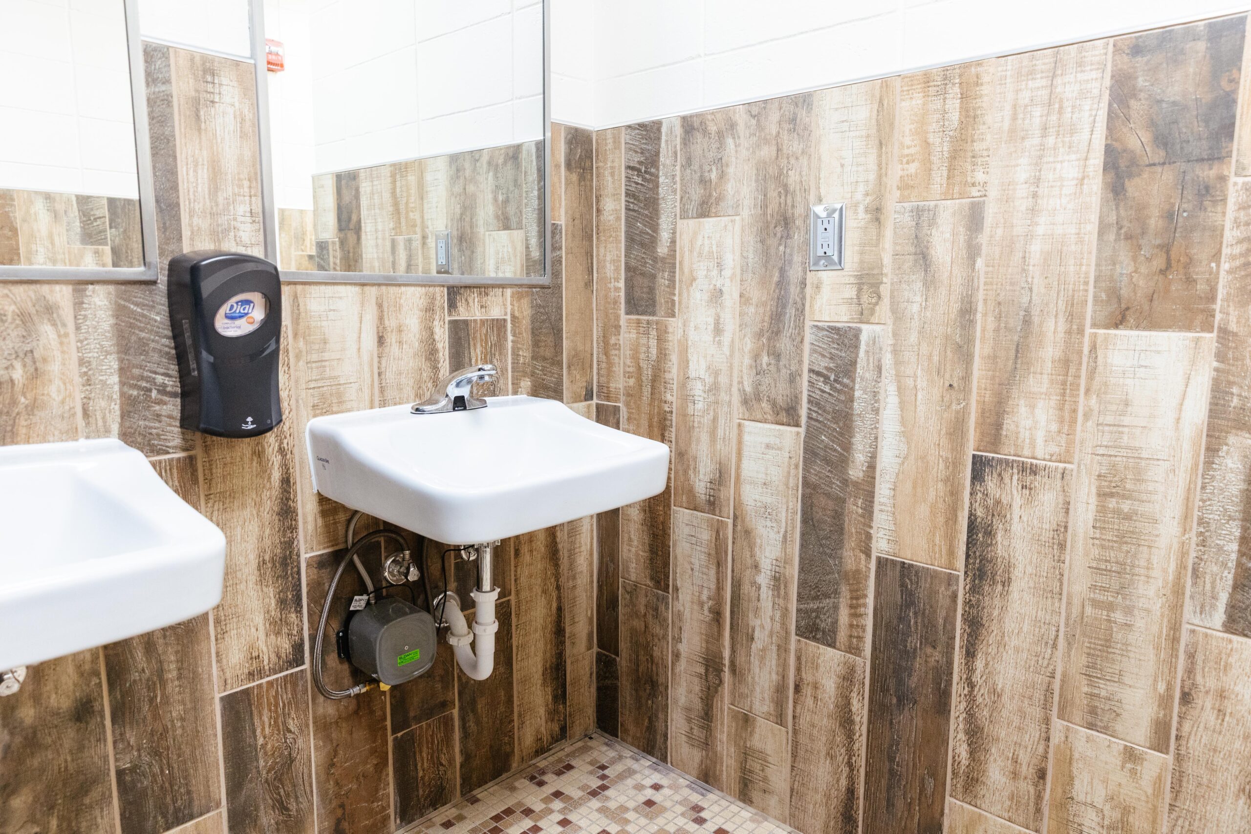 Updated school bathroom with new tile, modern fixtures, improved lighting, and refreshed finishes funded by Annual Fund donations
