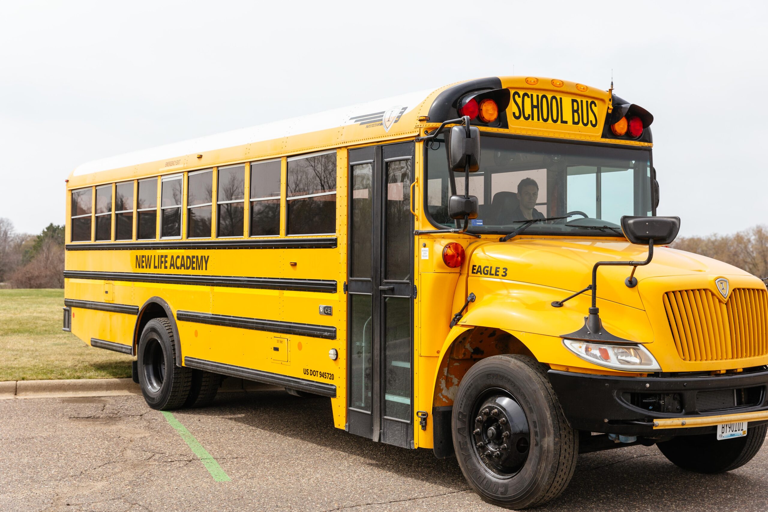 New mid-size yellow school bus purchased through Annual Fund donations for student transportation